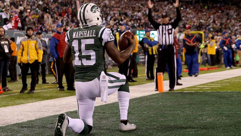 EAST RUTHERFORD, NJ - NOVEMBER 27: Brandon Marshall #15 of the New York Jets celebrates after scoring a one yard touchdown pass against Malcolm Butler #21 of the New England Patriots during the second quarter in the game at MetLife Stadium on November 27, 2016 in East Rutherford, New Jersey.