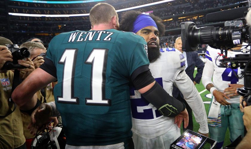 ARLINGTON, TEXAS - OCTOBER 20: Carson Wentz #11 of the Philadelphia Eagles hugs Ezekiel Elliott #21 of the Dallas Cowboys after the game at AT&T Stadium on October 20, 2019 in Arlington, Texas.