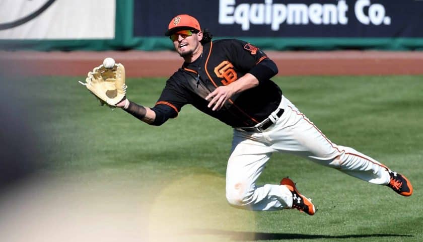 SCOTTSDALE, AZ - FEBRUARY 26: Jarrett Parker #6 of the San Francisco Giants makes a diving catch in the fifth inning of the spring training game against the Kansas City Royals at Scottsdale Stadium on February 26, 2018 in Scottsdale, Arizona.