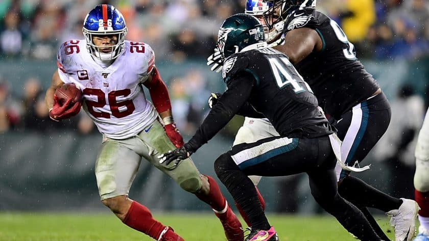 PHILADELPHIA, PENNSYLVANIA - DECEMBER 09: Running back Saquon Barkley #26 of the New York Giants carries the ball against the defense of the Philadelphia Eagles during the game at Lincoln Financial Field on December 09, 2019 in Philadelphia, Pennsylvania.
