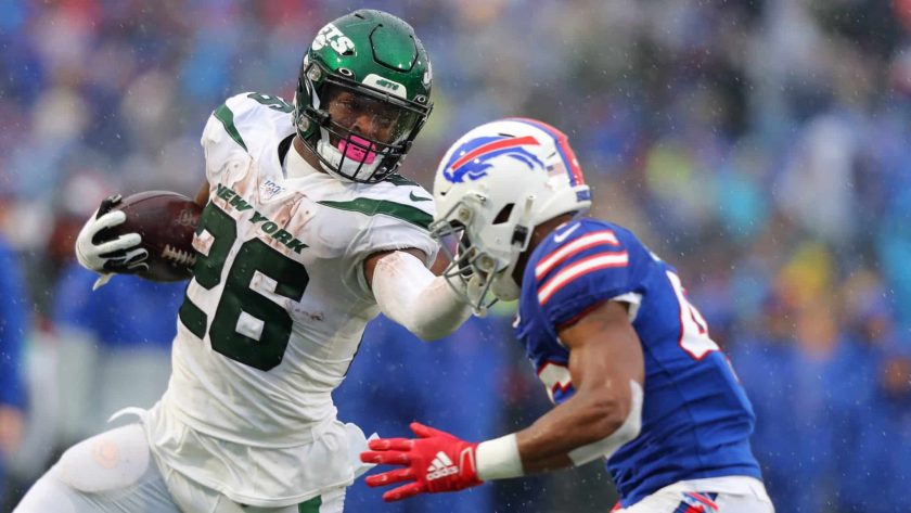 ORCHARD PARK, NY - DECEMBER 29: Le'Veon Bell #26 of the New York Jets runs the ball and tries to block Jaquan Johnson #46 of the Buffalo Bills during the first half at New Era Field on December 29, 2019 in Orchard Park, New York.