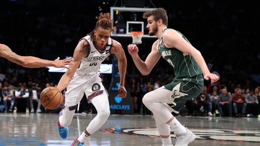 NEW YORK, NEW YORK - JANUARY 18: Nicolas Claxton #22 of the Brooklyn Nets dribbles against Dragan Bender #17 of the Milwaukee Bucks during their game at Barclays Center on January 18, 2020 in New York City. NOTE TO USER: User expressly acknowledges and agrees that, by downloading and/or using this photograph, user is consenting to the terms and conditions of the Getty Images License Agreement.