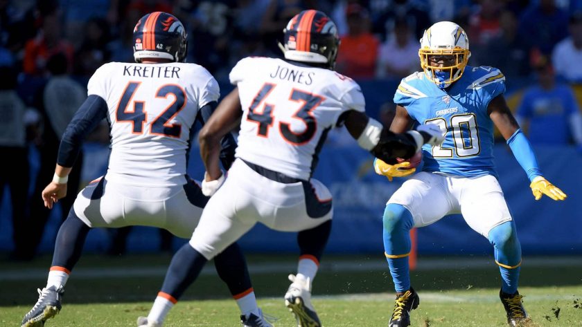 CARSON, CALIFORNIA - OCTOBER 06: Desmond King #20 of the Los Angeles Chargers deeks Casey Kreiter #42 and Joe Jones #43 of the Denver Broncos to score a touchdown from a punt return, to trail 17-7, during the third quarter in a 20-13 Broncos win at Dignity Health Sports Park on October 06, 2019 in Carson, California.