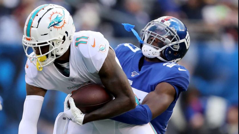 EAST RUTHERFORD, NEW JERSEY - DECEMBER 15: DeVante Parker #11 of the Miami Dolphins makes the catch as Deandre Baker #27 of the New York Giants defends at MetLife Stadium on December 15, 2019 in East Rutherford, New Jersey.
