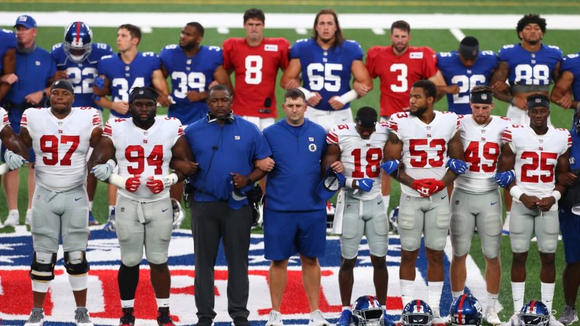 EAST RUTHERFORD, NEW JERSEY - AUGUST 28: New York Giants lock arms in a pregame moment of silence prior to the start of the Blue and White scrimmage at MetLife Stadium on August 28, 2020 in East Rutherford, New Jersey.