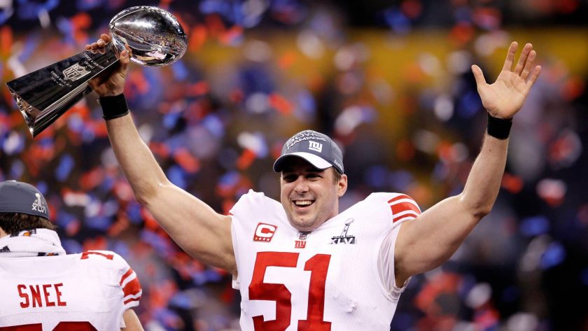 INDIANAPOLIS, IN - FEBRUARY 05: Zak DeOssie #51 of the New York Giants poses with the Vince Lombardi Trophy after the Giants defeated the Patriots by a score of 21-17 in Super Bowl XLVI at Lucas Oil Stadium on February 5, 2012 in Indianapolis, Indiana.