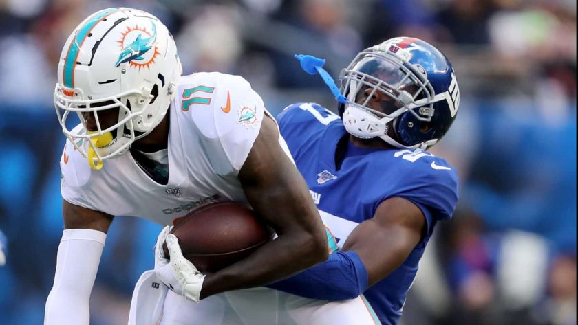 EAST RUTHERFORD, NEW JERSEY - DECEMBER 15: DeVante Parker #11 of the Miami Dolphins makes the catch as Deandre Baker #27 of the New York Giants defends at MetLife Stadium on December 15, 2019 in East Rutherford, New Jersey.