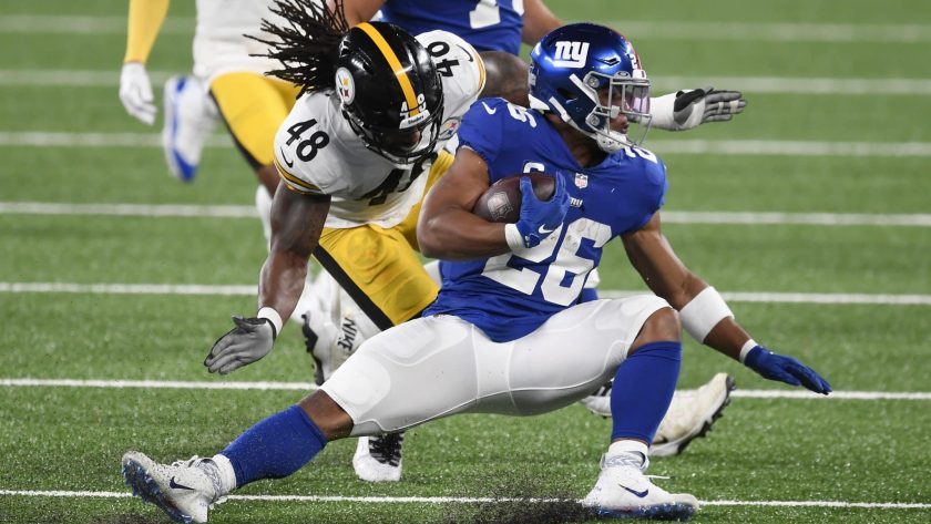EAST RUTHERFORD, NEW JERSEY - SEPTEMBER 14: Saquon Barkley #26 of the New York Giants carries the ball as Bud Dupree #48 of the Pittsburgh Steelers defends during the first half at MetLife Stadium on September 14, 2020 in East Rutherford, New Jersey.