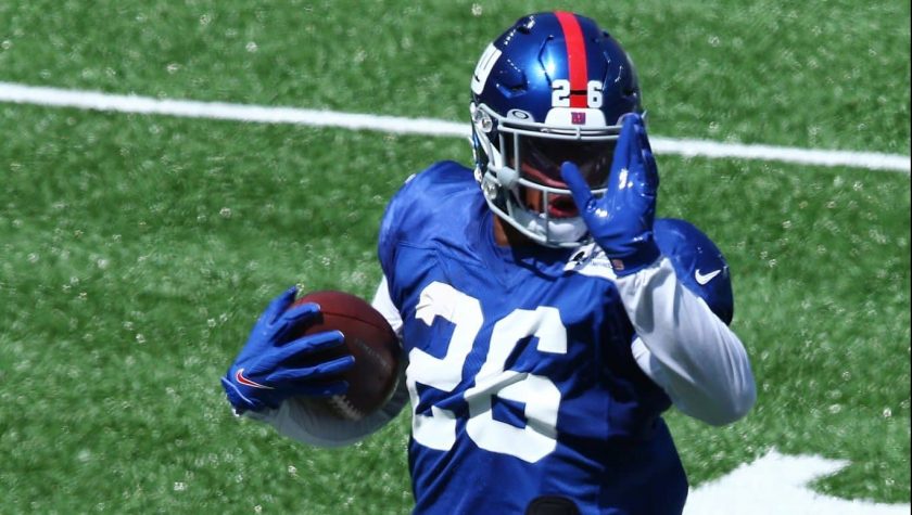 EAST RUTHERFORD, NEW JERSEY - SEPTEMBER 03: Saquon Barkley #26 of the New York Giants scores a touchdown during the Blue and White scrimmage at MetLife Stadium on September 03, 2020 in East Rutherford, New Jersey.