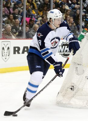 Feb 27, 2016; Pittsburgh, PA, USA; Winnipeg Jets defenseman Jacob Trouba (8) carries the puck from behind his net against the Pittsburgh Penguins during the second period at the CONSOL Energy Center. The Penguins won 4-1. Mandatory Credit: Charles LeClaire-USA TODAY Sports