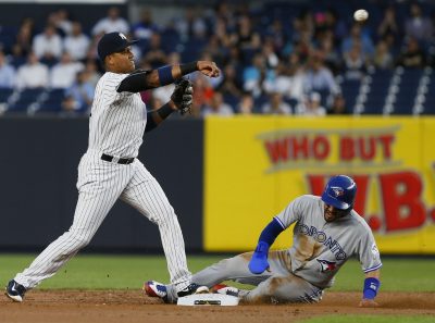 Sep 7, 2016; Bronx, NY, USA; New York Yankees second baseman Starlin Castro (14) makes the throw to first to complete the double over Toronto Blue Jays second baseman Devon Travis (29) in the first inning at Yankee Stadium. Mandatory Credit: Noah K. Murray-USA TODAY Sports