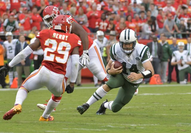 Sep 25, 2016; Kansas City, MO, USA; New York Jets quarterback Ryan Fitzpatrick (14) runs the ball as Kansas City Chiefs strong safety Eric Berry (29) attempts the tackle during the second half at Arrowhead Stadium. The Chiefs won 24-3. Mandatory Credit: Denny Medley-USA TODAY Sports