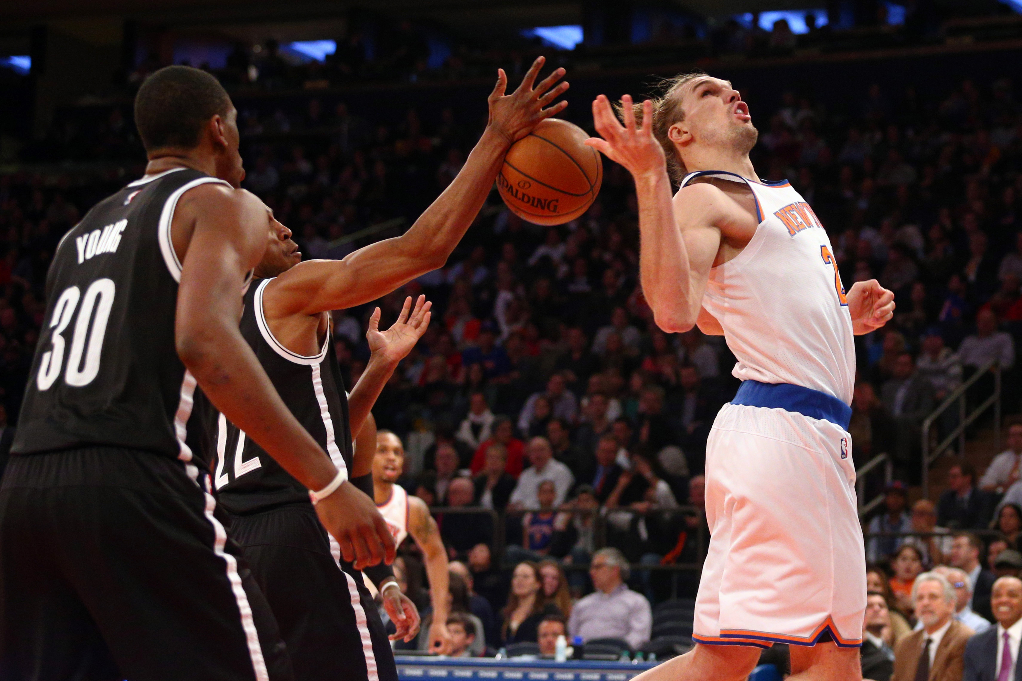 Apr 1, 2015; New York, NY, USA; New York Knicks power forward Lou Amundson (21) loses the ball as he drives against Brooklyn Nets shooting guard Markel Brown (22) and Nets small forward Thaddeus Young (30) during the third quarter at Madison Square Garden. The Nets defeated the Knicks 100-98. Mandatory Credit: Brad Penner-USA TODAY Sports