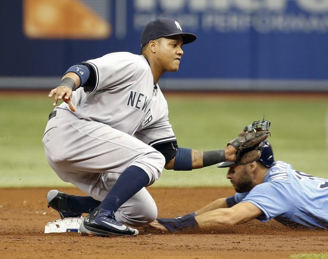 Jul 31, 2016; St. Petersburg, FL, USA;Tampa Bay Rays center fielder Kevin Kiermaier (39) steals second base as New York Yankees second baseman Starlin Castro (14) attempts to tag him out during the second inning at Tropicana Field. Mandatory Credit: Kim Klement-USA TODAY Sports