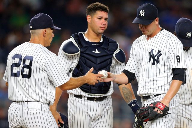 Aug 16, 2016; Bronx, NY, USA; New York Yankees relief pitcher Anthony Swarzak (41) hands the ball off to New York Yankees manager Joe Girardi (28) after being taken out of the game against the Toronto Blue Jays during the sixth inning at Yankee Stadium. Mandatory Credit: Brad Penner-USA TODAY Sports