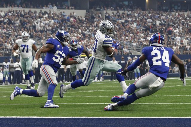 Sep 11, 2016; Arlington, TX, USA; Dallas Cowboys running back Ezekiel Elliott (21) runs the ball against New York Giants cornerback Eli Apple (24) and outside linebacker Jonathan Casillas (52) in the first quarter at AT&T Stadium. Mandatory Credit: Tim Heitman-USA TODAY Sports