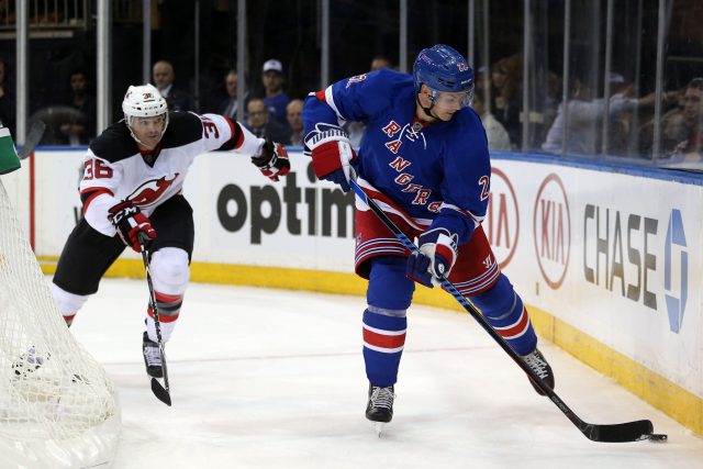 Sep 29, 2016; New York, NY, USA; New York Rangers defenseman Nick Holden (22) plays the puck against New Jersey Devils right wing Nick Lappin (36) during the second period of a preseason hockey game at Madison Square Garden. Mandatory Credit: Brad Penner-USA TODAY Sports
