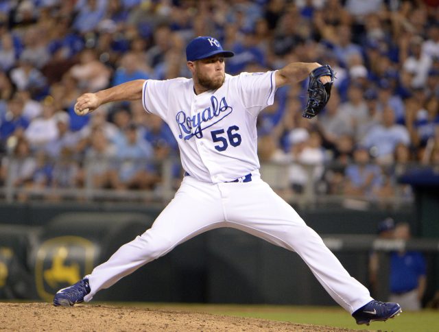 Aug 14, 2015; Kansas City, MO, USA; Kansas City Royals relief pitcher Greg Holland (56) delivers a pitch against the Los Angeles Angels in the ninth inning at Kauffman Stadium. Kansas City won the game 4-1. Mandatory Credit: John Rieger-USA TODAY Sports