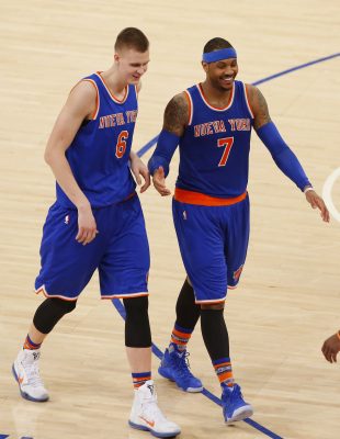 Mar 24, 2016; New York, NY, USA; New York Knicks forward Kristaps Porzingis (6) and forward Carmelo Anthony (7) laugh on the court during second half time out against the Chicago Bulls at Madison Square Garden. The Knicks won 106-94. Mandatory Credit: Noah K. Murray-USA TODAY Sports
