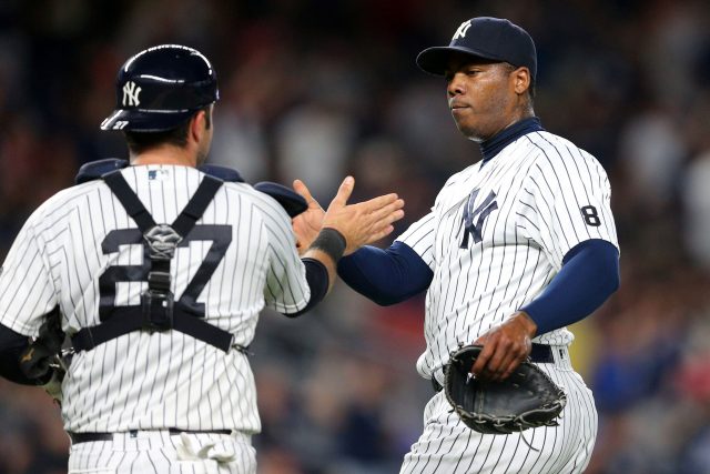 Jul 17, 2016; Bronx, NY, USA; New York Yankees relief pitcher Aroldis Chapman (54) and catcher Austin Romine (27) celebrate after defeating the Boston Red Sox at Yankee Stadium. Mandatory Credit: Brad Penner-USA TODAY Sports