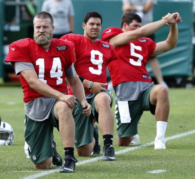 Aug 4, 2016; Florham Park, NJ, USA; New York Jets quarterback Ryan Fitzpatrick (14), quarterback Bryce Petty (9) and quarterback Christian Hackenberg (5) stretching during practice at Atlantic Health Jets Training Center. Mandatory Credit: Noah K. Murray-USA TODAY Sports