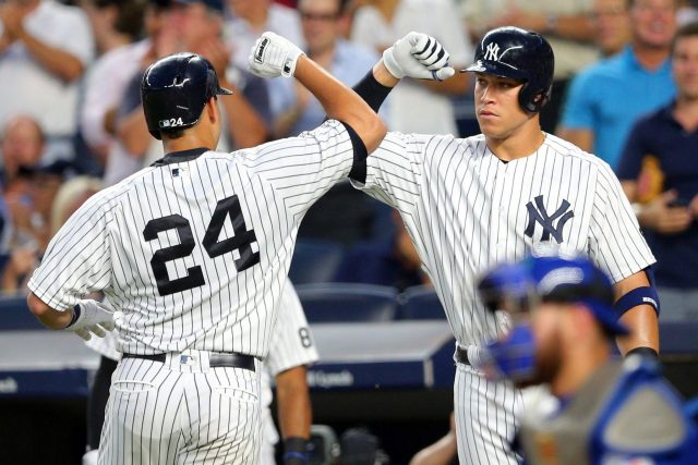 Aug 16, 2016; Bronx, NY, USA; New York Yankees catcher Gary Sanchez (24) is congratulates by right fielder Aaron Judge (99) after hitting a solo home run against the Toronto Blue Jays at Yankee Stadium. Mandatory Credit: Brad Penner-USA TODAY Sports