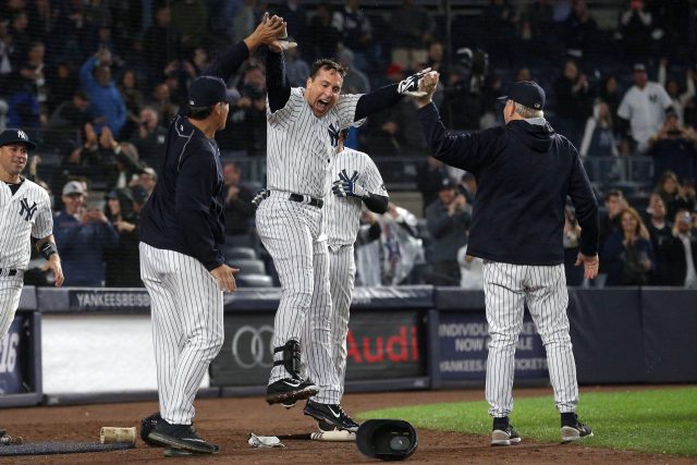 Sep 28, 2016; Bronx, NY, USA; New York Yankees first baseman Mark Teixeira (25) celebrates with teammates after hitting a walk off grand slam against the Boston Red Sox during the ninth inning at Yankee Stadium. Mandatory Credit: Brad Penner-USA TODAY Sports