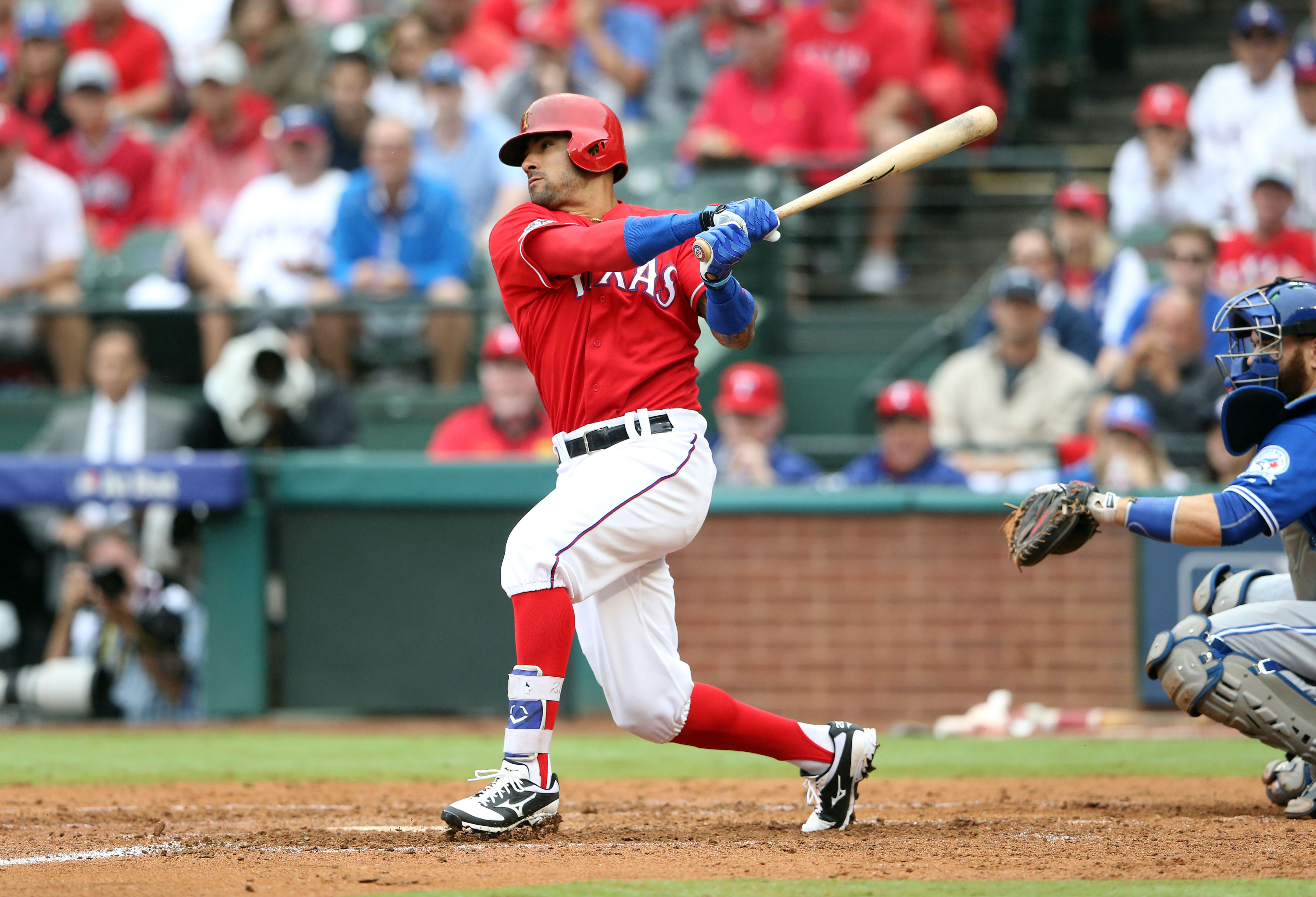 Oct 7, 2016; Arlington, TX, USA; Texas Rangers center fielder Ian Desmond (20) hits an RBI single against the Toronto Blue Jays during the fourth inning of game two of the 2016 ALDS playoff baseball series at Globe Life Park in Arlington. Mandatory Credit: Kevin Jairaj-USA TODAY Sports