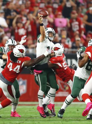 Oct 17, 2016; Glendale, AZ, USA; New York Jets quarterback Ryan Fitzpatrick (14) throws the ball as he is hit by Arizona Cardinals linebacker Chandler Jones (55) in the first quarter at University of Phoenix Stadium. Mandatory Credit: Mark J. Rebilas-USA TODAY Sports