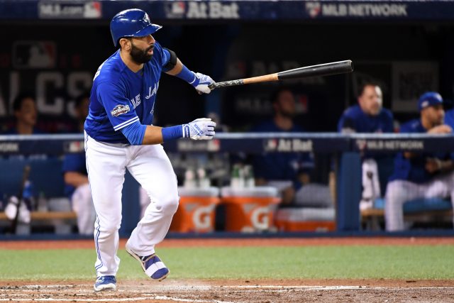 Oct 19, 2016; Toronto, Ontario, CAN; Toronto Blue Jays right fielder Jose Bautista (19) hits a single during the sixth inning against the Cleveland Indians in game five of the 2016 ALCS playoff baseball series at Rogers Centre. Mandatory Credit: Nick Turchiaro-USA TODAY Sports