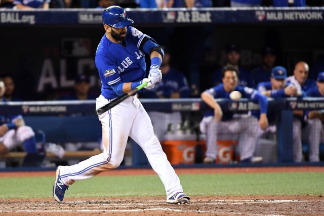 Oct 19, 2016; Toronto, Ontario, CAN; Toronto Blue Jays right fielder Jose Bautista (19) hits a double during the ninth inning against the Cleveland Indians in game five of the 2016 ALCS playoff baseball series at Rogers Centre. Mandatory Credit: Nick Turchiaro-USA TODAY Sports