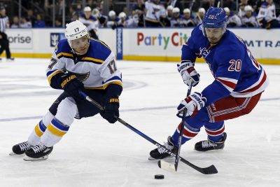 Nov 1, 2016; New York, NY, USA; New York Rangers left wing Chris Kreider (20) knocks the puck away from St. Louis Blues left wing Jaden Schwartz (17) during the second period at Madison Square Garden. Mandatory Credit: Adam Hunger-USA TODAY Sports