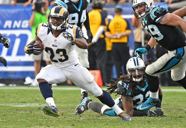 Nov 6, 2016; Los Angeles, CA, USA; Los Angeles Rams running back Benny Cunningham (23) carries the ball past Carolina Panthers free safety Tre Boston (33) in the second half of the game at the Los Angeles Memorial Coliseum. Mandatory Credit: Jayne Kamin-Oncea-USA TODAY Sports