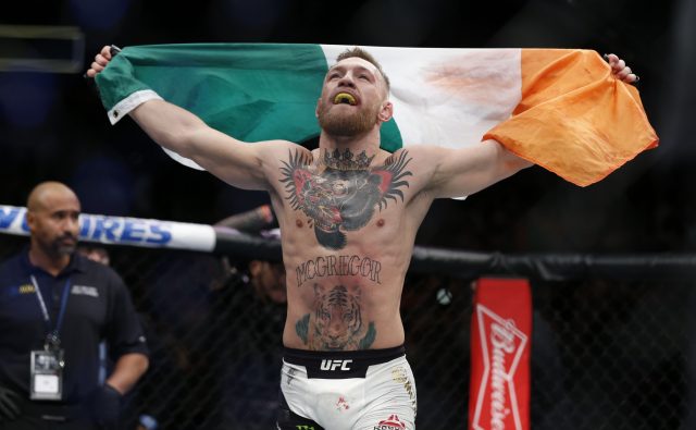 Nov 12, 2016; New York, NY, USA;  Conor McGregor (blue gloves) celebrates after defeating Eddie Alvarez (red gloves) in their lightweight title bout during UFC 205 at Madison Square Garden. Mandatory Credit: Adam Hunger-USA TODAY Sports