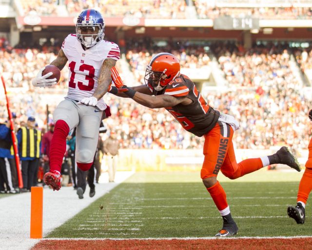 Nov 27, 2016; Cleveland, OH, USA; New York Giants wide receiver Odell Beckham (13) gets hit by Cleveland Browns defensive back Marcus Burley (26) as he runs the ball into the endzone for a touchdown during the second quarter at FirstEnergy Stadium. Mandatory Credit: Scott R. Galvin-USA TODAY Sports