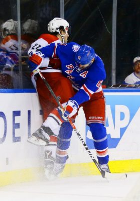 Nov 29, 2016; New York, NY, USA; New York Rangers right wing Rick Nash (61) and Carolina Hurricanes defenseman Justin Faulk (27) come together at the boards during the second period at Madison Square Garden. Mandatory Credit: Andy Marlin-USA TODAY Sports