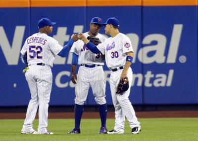 Sep 19, 2016; New York City, NY, USA; New York Mets outfielders Yoenis Cespedes (52), Curtis Granderson (3) and Michael Conforto (30) during a pitching change in the seventh inning against the Atlanta Braves at Citi Field. Mandatory Credit: Wendell Cruz-USA TODAY Sports