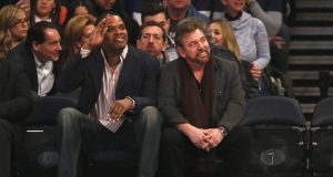 James Dolan slaps Charles Oakley in the face by sitting next to Latrell Sprewell 