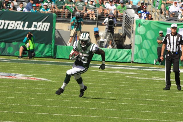 New York Jets head Chad Pennington throws a pass over a leaping Miami  Dolphins Jason Taylor in the first quarter at Giants Stadium in East  Rutherford, New Jersey on October 15, 2006.