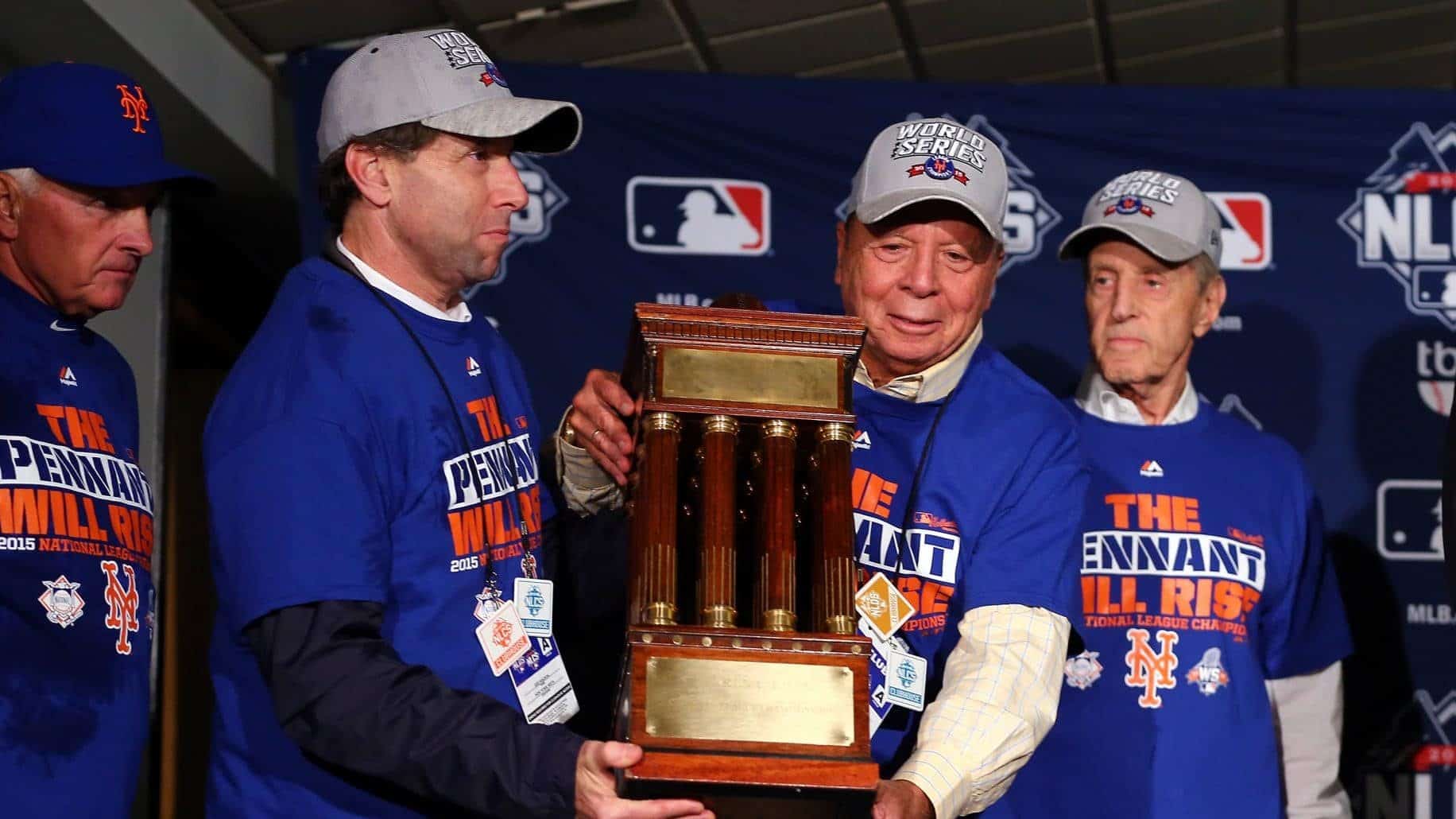 CHICAGO, IL - OCTOBER 21: (L-R) Chief Operating Officer Jeff Wilpon, Chief Executive Officer Saul Katz and Owner Fred Wilpon of the New York Mets pose with the NLCS trophy after defeating the Chicago Cubs in game four of the 2015 MLB National League Championship Series at Wrigley Field on October 21, 2015 in Chicago, Illinois. The Mets defeated the Cubs with a score of 8 to 3 to sweep the Championship Series.