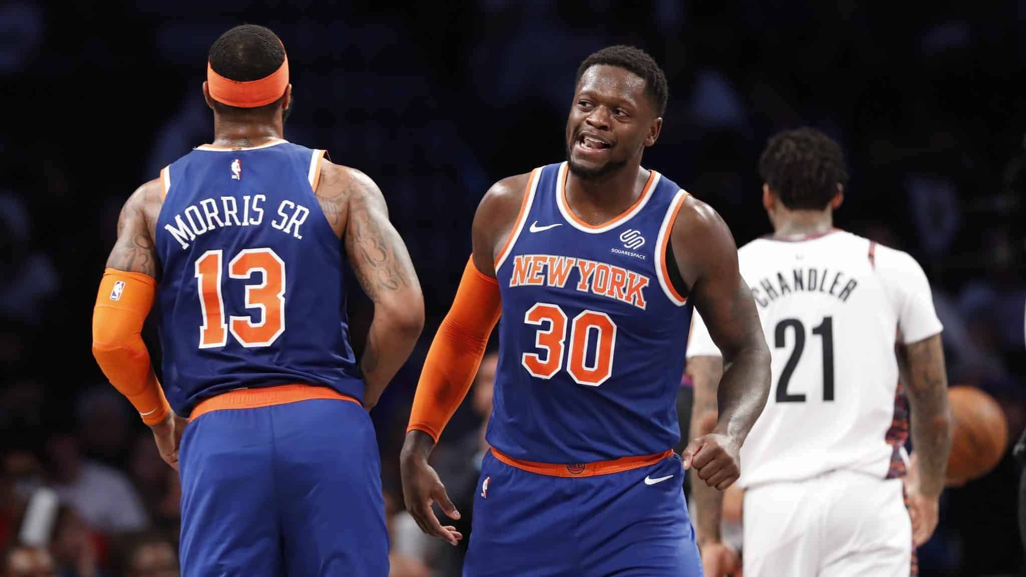 New York Knicks forward Julius Randle (30) looks around Knicks forward Marcus Morris Sr. (13) as Brooklyn Nets forward Wilson Chandler (21) walks away during the second half of an NBA basketball game, Thursday, Dec. 26, 2019, in New York.