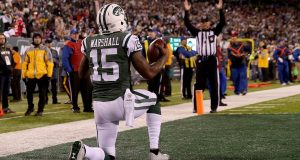 EAST RUTHERFORD, NJ - NOVEMBER 27: Brandon Marshall #15 of the New York Jets celebrates after scoring a one yard touchdown pass against Malcolm Butler #21 of the New England Patriots during the second quarter in the game at MetLife Stadium on November 27, 2016 in East Rutherford, New Jersey.