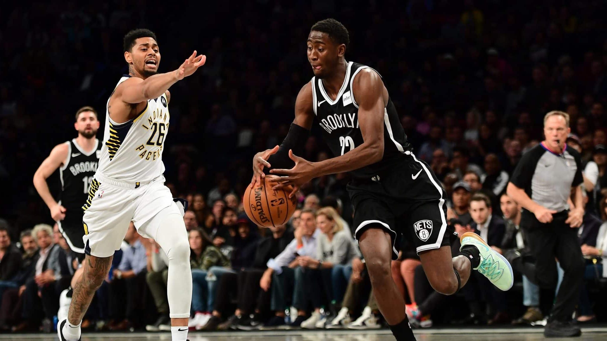 NEW YORK, NEW YORK - OCTOBER 30: Caris LeVert #22 of the Brooklyn Nets takes control of the ball as Jeremy Lamb #26 of the Indiana Pacers guards him during the first half of their game at Barclays Center on October 30, 2019 in the Brooklyn borough of New York City. NOTE TO USER: User expressly acknowledges and agrees that, by downloading and or using this Photograph, user is consenting to the terms and conditions of the Getty Images License Agreement.
