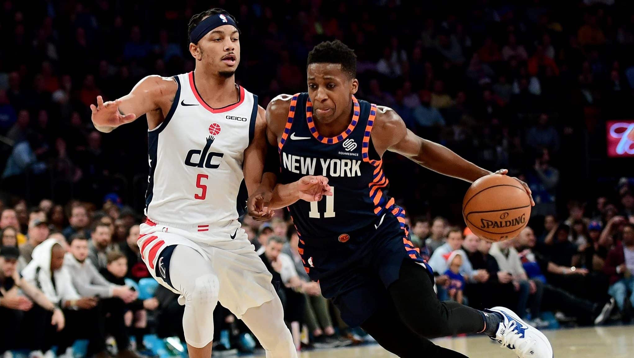 NEW YORK, NEW YORK - DECEMBER 23: Frank Ntilikina #11 of the New York Knicks drives past Justin Robinson #5 of the Washington Wizards during the second half of their game at Madison Square Garden on December 23, 2019 in New York City. NOTE TO USER: User expressly acknowledges and agrees that, by downloading and or using this photograph, User is consenting to the terms and conditions of the Getty Images License Agreement.