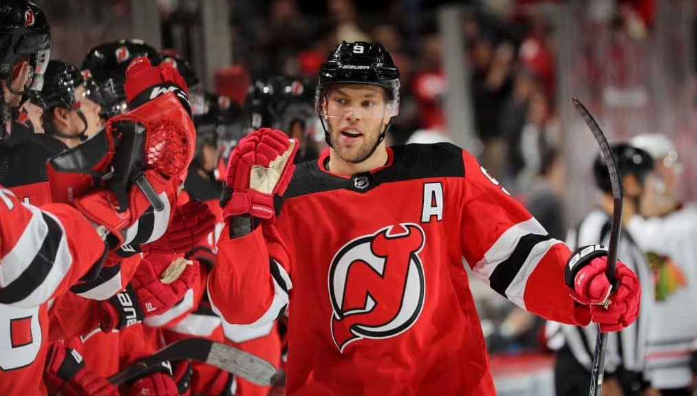 NEWARK, NEW JERSEY - DECEMBER 06: Taylor Hall #9 of the New Jersey Devils celebrates his goal with teammates on the bench in the first period against the Chicago Blackhawks at Prudential Center on December 06, 2019 in Newark, New Jersey.