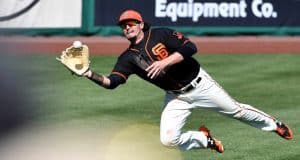 SCOTTSDALE, AZ - FEBRUARY 26: Jarrett Parker #6 of the San Francisco Giants makes a diving catch in the fifth inning of the spring training game against the Kansas City Royals at Scottsdale Stadium on February 26, 2018 in Scottsdale, Arizona.
