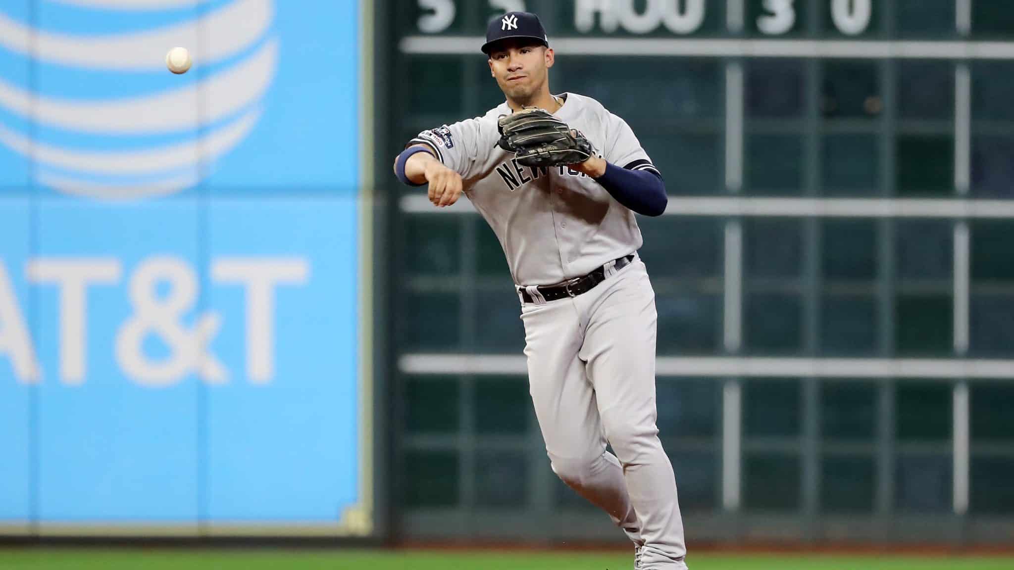 HOUSTON, TEXAS - OCTOBER 19: Gleyber Torres #25 of the New York Yankees throws out the runner against the New York Yankees during the third inning in game six of the American League Championship Series at Minute Maid Park on October 19, 2019 in Houston, Texas.