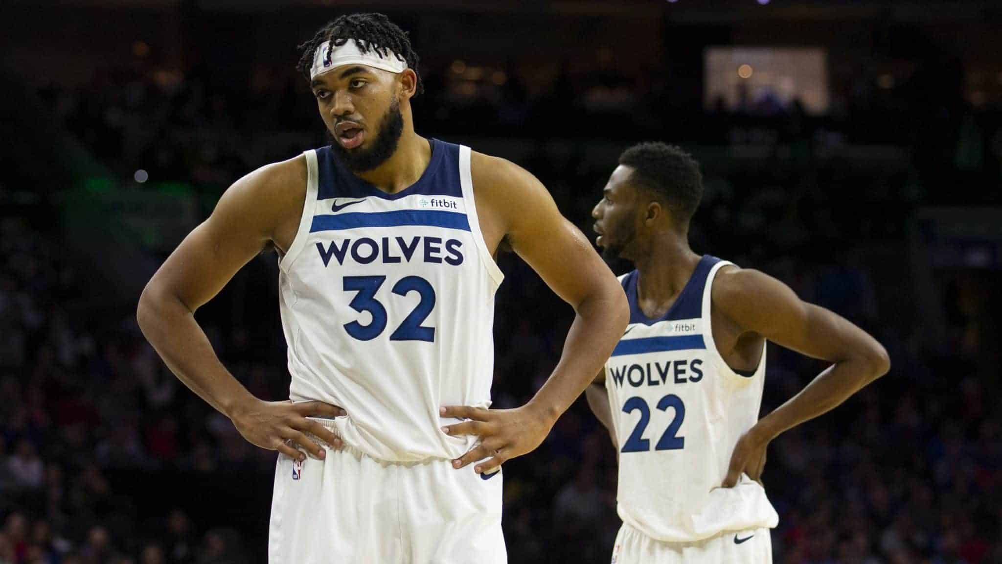 PHILADELPHIA, PA - OCTOBER 30: Karl-Anthony Towns #32 and Andrew Wiggins #22 of the Minnesota Timberwolves look on against the Philadelphia 76ers at the Wells Fargo Center on October 30, 2019 in Philadelphia, Pennsylvania. NOTE TO USER: User expressly acknowledges and agrees that, by downloading and or using this photograph, User is consenting to the terms and conditions of the Getty Images License Agreement.