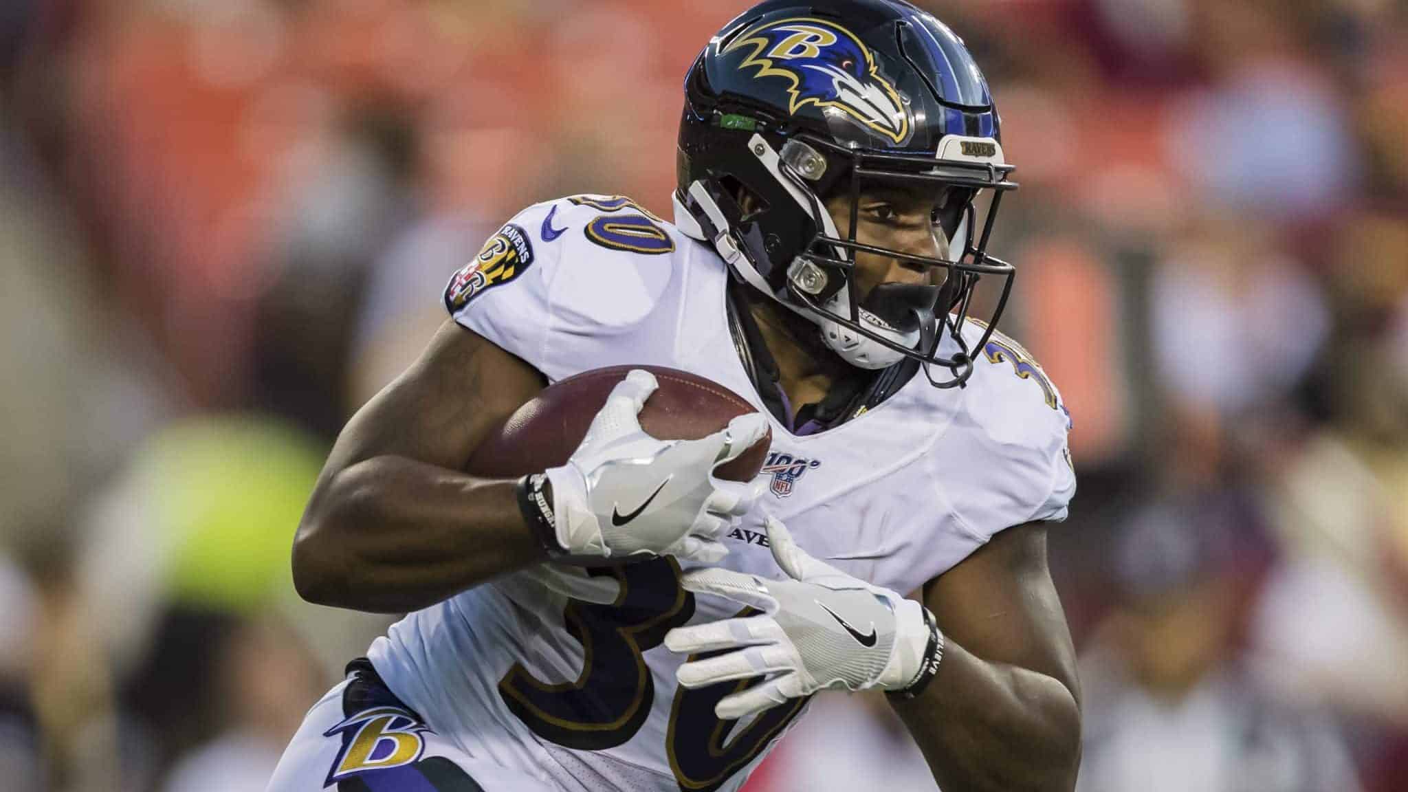 LANDOVER, MD - AUGUST 29: Kenneth Dixon #30 of the Baltimore Ravens carries the ball during the first half of a preseason game against the Washington Redskins at FedExField on August 29, 2019 in Landover, Maryland.