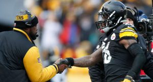 PITTSBURGH, PA - JANUARY 08: Le'Veon Bell #26 of the Pittsburgh Steelers celebrates with head coach Mike Tomlin after scoring a touchdown during the second quarter against the Miami Dolphins in the AFC Wild Card game at Heinz Field on January 8, 2017 in Pittsburgh, Pennsylvania.